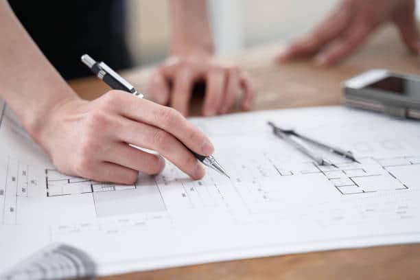 An architect working on a blueprint.